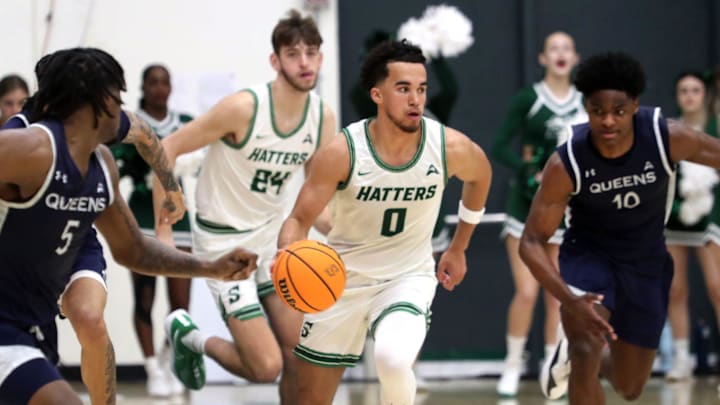 Stetson's Alec Oglesby (0) dribbles down the court against Queens, Thursday, Feb. 22, 2024 at the