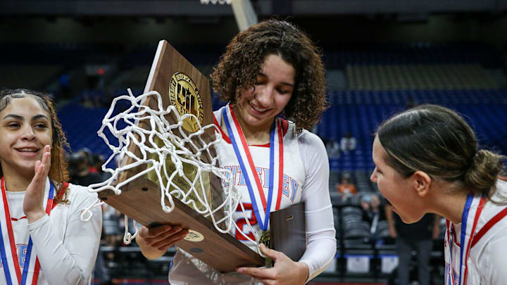 Monterey's Aaliyah Chavez holds the Class 5A Division II state championship girls basketball trophy on Saturday, March 1, 2025, at the Alamodome in San Antonio. Monterey defeated Liberty Hill 64-35.