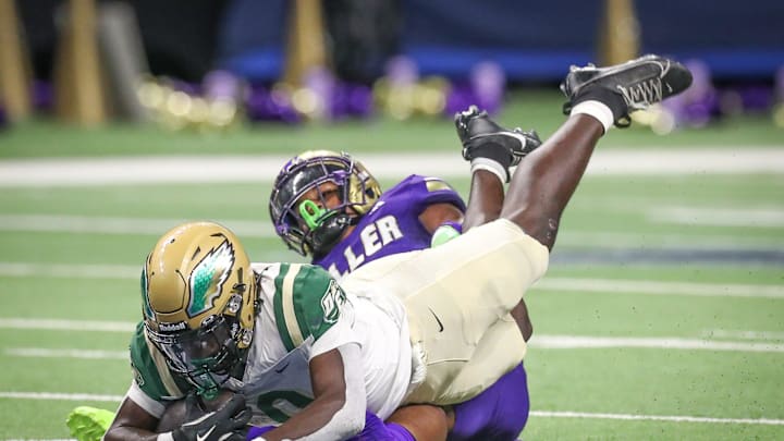 DeSoto's Myson Cook Johnson is tripped up by Miller's Delson Cavaness during Friday's game at the Alamodome on Sept. 13, 2024, in San Antonio, Texas. DeSoto's Myson Cook Johnson is tripped up by Miller's Delson Cavaness during Friday's game at the Alamodome on Sept. 13, 2024, in San Antonio, Texas.