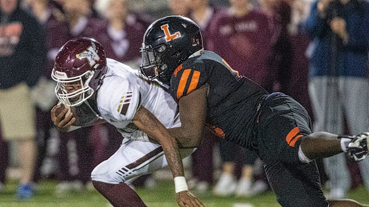 Niceville (15) Johnny Lewis jr is tackled by Lakeland (0) Malik Morris Friday December 6 , 2024 in Lakeland Fl.