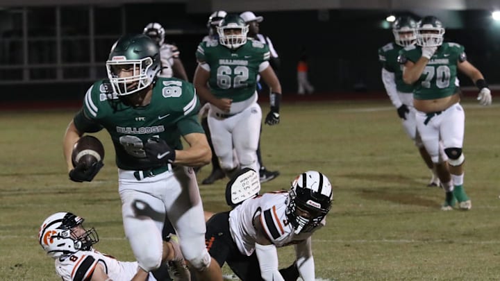 Flagler Palm Coast's Roman Caliendo (81) breaks free from a couple of Spruce Creek defenders during the Region 1-7A quarterfinals, Friday, Nov. 15, 2024.