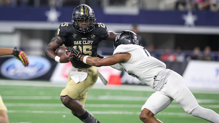 South Oak Cliff's Demond Williams is tackled by Richmond Randle's Ryan Mallory during the Class 5A, Division II State Championship game on Friday, Dec. 20, 2024, at AT&T Stadium in Arlington, Texas.