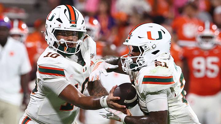 Oct 3, 2026; Clemson, South Carolina, USA; Miami Hurricanes quarterback Darian Mensah (10) hands the ball off to running back Javian Mallory (21) during the fourth quarter against the Clemson Tigers at Memorial Stadium. Mandatory Credit: Ashley Tumlin-Imagn Images Oct 3, 2026; Clemson, South Carolina, USA; Miami Hurricanes quarterback Darian Mensah (10) hands the ball off to running back Javian Mallory (21) during the fourth quarter against the Clemson Tigers at Memorial Stadium. Mandatory Credit: Ashley Tumlin-Imagn Images