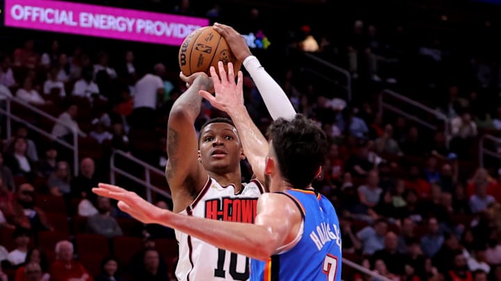 Apr 4, 2025; Houston, Texas, USA; Houston Rockets forward Jabari Smith Jr (10) shoots outside against Oklahoma City Thunder forward Chet Holmgren (7) during the first quarter at Toyota Center. Mandatory Credit: Erik Williams-Imagn Images