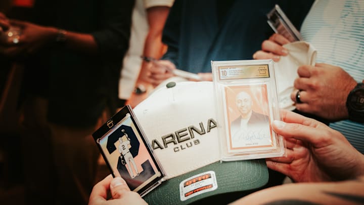 Arena Club graded cards with an Arena Club hat