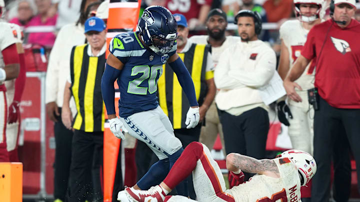 Sep 25, 2025; Glendale, Arizona, USA; Seattle Seahawks safety Julian Love (20) reacts after a tackling Arizona Cardinals tight end Trey McBride (85) in the second quarter at State Farm Stadium.