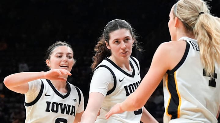 Iowa guard Taylor McCabe (2) and Iowa center Ava Heiden (5) high-five Iowa guard Kylie Feuerbach (4) during a game against the Lindenwood Lions Dec. 13, 2025 at Carver-Hawkeye Arena in Iowa City, Iowa. Iowa guard Taylor McCabe (2) and Iowa center Ava Heiden (5) high-five Iowa guard Kylie Feuerbach (4) during a game against the Lindenwood Lions Dec. 13, 2025 at Carver-Hawkeye Arena in Iowa City, Iowa.