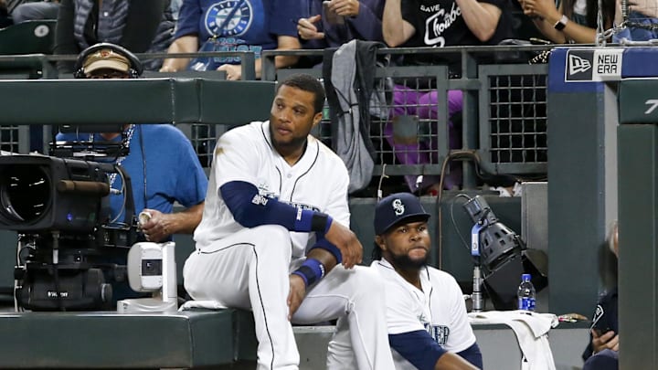 Seattle Mariners first baseman Robinson Cano (left) and relief pitcher Alex Colome (48) sit on the steps of the dugout during the eighth inning against the New York Yankees at Safeco Field in 2018.