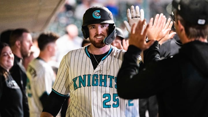 Charlotte Knights first baseman Tim Elko celebrates in the dugout.