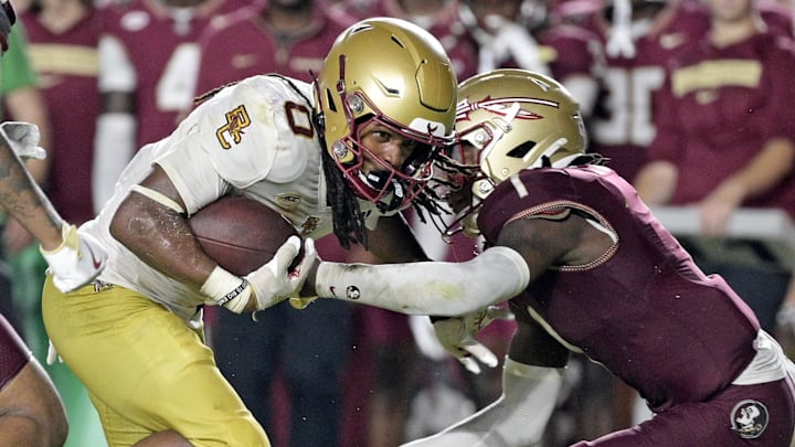 Sep 2, 2024; Tallahassee, Florida, USA; Boston College Eagles running back Treshaun Ward (0) runs the ball and is tackled by Florida State Seminoles defensive back Shyheim Brown (1) during the second half at Doak S. Campbell Stadium. Mandatory Credit: Melina Myers-Imagn Images