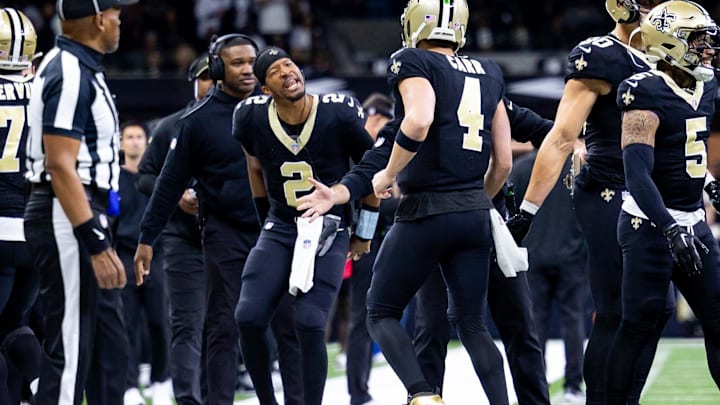 Jan 7, 2024; New Orleans, Louisiana, USA;  New Orleans Saints quarterback Jameis Winston (2) greets quarterback Derek Carr (4) after a touchdown pass against the Atlanta Falcons during the first half at Caesars Superdome. Mandatory Credit: Stephen Lew-Imagn Images