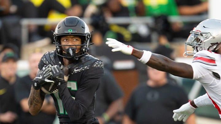 Oregon’s Tez Johnson pulls down a Dillon Gabriel ahead of Ohio State’s Denzel Burke on his way to a second-quarter touchdown at Autzen Stadium Saturday, Oct. 12, 2024.