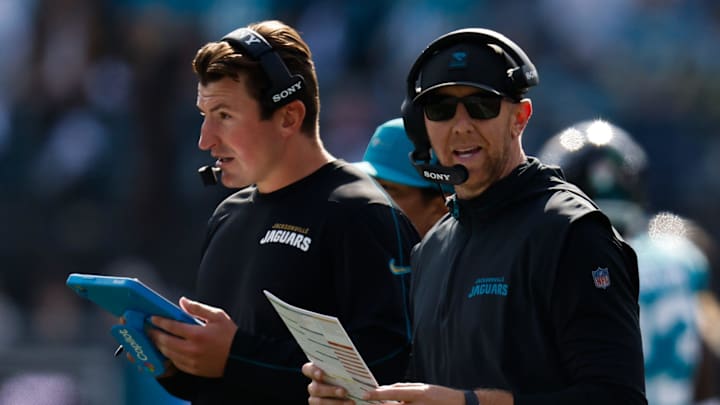 Jacksonville Jaguars offensive coordinator Grant Udinski, left listens on the headset as Jacksonville Jaguars head coach Liam Coen call a play during the first quarter in an NFL football AFC Wild Card playoff matchup, Sunday, Jan. 11, 2026, in Jacksonville, Fla. Bills lead 10-7 at the half over the Jaguars. [Doug Engle/Florida Times-Union]