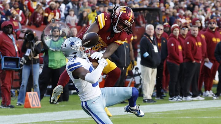 Nov 24, 2024; Landover, Maryland, USA; Washington Commanders wide receiver Noah Brown (85) attempts to Catcha pass as Dallas Cowboys cornerback Josh Butler (31) defends during the second quarter at Northwest Stadium. Mandatory Credit: Geoff Burke-Imagn Images