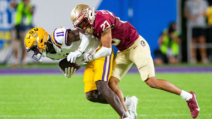 Florida State Seminoles defensive back Fentrell Cypress II (23) tackles LSU Tigers wide receiver Brian Thomas Jr. (11) during a game at Camping World Stadium on Sunday, Sept. 3, 2023.