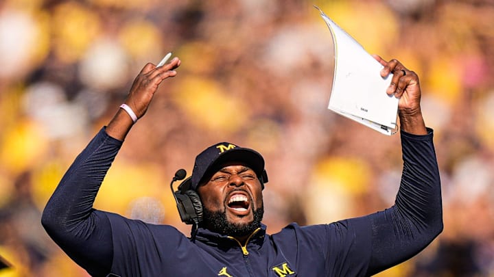 Michigan head coach Sherrone Moore cheers on before a play against Washington during the first half at Michigan Stadium in Ann Arbor on Saturday, Oct. 18, 2025. Michigan head coach Sherrone Moore cheers on before a play against Washington during the first half at Michigan Stadium in Ann Arbor on Saturday, Oct. 18, 2025.