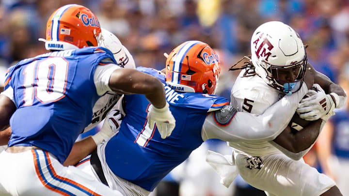 Sep 14, 2024; Gainesville, Florida, USA; Florida Gators defensive end Justus Boone (1) tackles Texas A&M Aggies running back Amari Daniels (5) during the first half at Ben Hill Griffin Stadium. Mandatory Credit: Matt Pendleton-Imagn Images