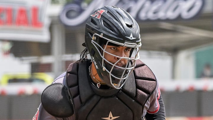 Visalia Rawhide's Christian Cerda goes after Fresno Grizzlies' Luis Mendez who missed the plate on Tuesday, May 9, 2023. Visalia Rawhide's Christian Cerda goes after Fresno Grizzlies' Luis Mendez who missed the plate on Tuesday, May 9, 2023.