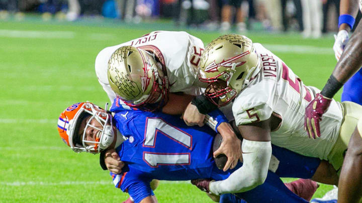 Florida Gators quarterback Max Brown (17) gets stopped by Florida State Seminoles defensive lineman Jared Verse (5) and Florida State Seminoles defensive lineman Braden Fiske (55) during first half action as Florida takes on Florida State at Steve Spurrier Field at Ben Hill Griffin Stadium in Gainesville, FL on Saturday, November 25, 2023. [Alan Youngblood/Gainesville Sun]