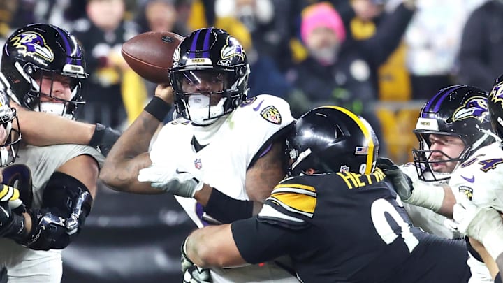 Jan 4, 2026; Pittsburgh, Pennsylvania, USA; Pittsburgh Steelers defensive tackle Cameron Heyward (97) tackles Baltimore Ravens quarterback Lamar Jackson (8) during the second half at Acrisure Stadium. Mandatory Credit: Charles LeClaire-Imagn Images