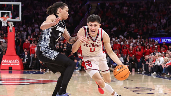 Mar 3, 2026; New York, New York, USA;  St. John's basketball guard Dylan Darling (0) drives past Georgetown Hoyas guard Malik Mack (2) in the second half at Madison Square Garden.