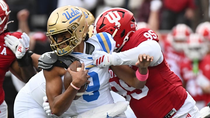 Oct 25, 2025; Bloomington, Indiana, USA; Indiana Hoosiers defensive lineman Tyrique Tucker (95) brings down UCLA Bruins quarterback Nico Iamaleava (9) during the first half at Memorial Stadium. Mandatory Credit: Robert Goddin-Imagn Images Oct 25, 2025; Bloomington, Indiana, USA; Indiana Hoosiers defensive lineman Tyrique Tucker (95) brings down UCLA Bruins quarterback Nico Iamaleava (9) during the first half at Memorial Stadium. Mandatory Credit: Robert Goddin-Imagn Images