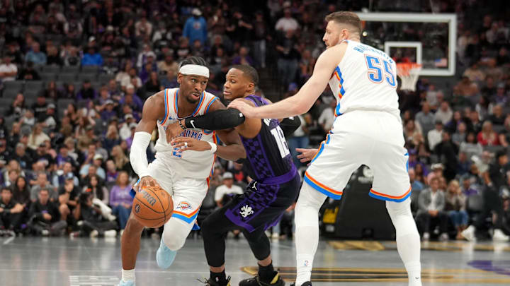 Nov 7, 2025; Sacramento, California, USA; Oklahoma City Thunder guard Shai Gilgeous-Alexander (2) dribbles past Sacramento Kings guard Russell Westbrook (18) in the third quarter at the Golden 1 Center. Mandatory Credit: Cary Edmondson-Imagn Images Nov 7, 2025; Sacramento, California, USA; Oklahoma City Thunder guard Shai Gilgeous-Alexander (2) dribbles past Sacramento Kings guard Russell Westbrook (18) in the third quarter at the Golden 1 Center. Mandatory Credit: Cary Edmondson-Imagn Images