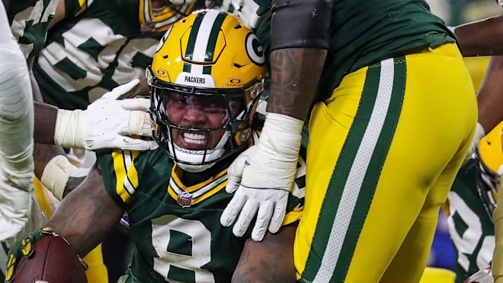 Green Bay Packers running back Josh Jacobs (8) celebrates after scoring his third rushing touchdown against the 49ers.