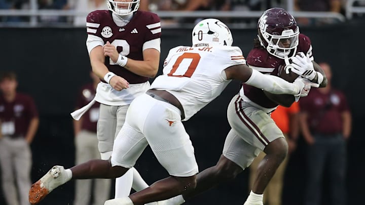 Oct 25, 2025; Starkville, Mississippi, USA; Mississippi State Bulldogs running back Davon Booth (6) runs the ball as Texas Longhorns linebacker Anthony Hill Jr. (0) makes the tackle during the third quarter at Davis Wade Stadium at Scott Field. Oct 25, 2025; Starkville, Mississippi, USA; Mississippi State Bulldogs running back Davon Booth (6) runs the ball as Texas Longhorns linebacker Anthony Hill Jr. (0) makes the tackle during the third quarter at Davis Wade Stadium at Scott Field.