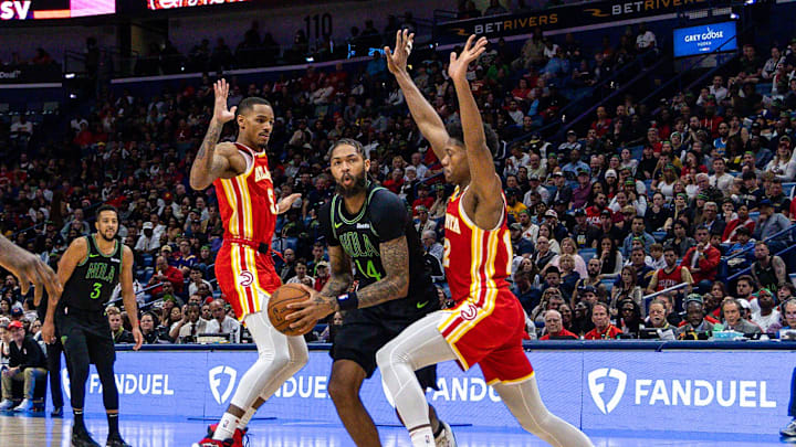 Nov 4, 2023; New Orleans, Louisiana, USA; New Orleans Pelicans forward Brandon Ingram (14) dribbles against Atlanta Hawks guard Dejounte Murray (5) and forward De'Andre Hunter (12) during the second half at Smoothie King Center. Mandatory Credit: Stephen Lew-USA TODAY Sports Nov 4, 2023; New Orleans, Louisiana, USA; New Orleans Pelicans forward Brandon Ingram (14) dribbles against Atlanta Hawks guard Dejounte Murray (5) and forward De'Andre Hunter (12) during the second half at Smoothie King Center. Mandatory Credit: Stephen Lew-USA TODAY Sports