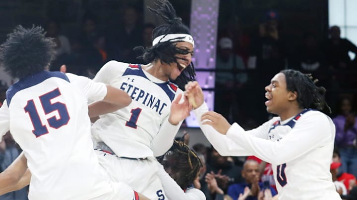 Stepinac  s Boogie Fland and Danny Carbuccia celebrate with teammates after defeating Nazareth in