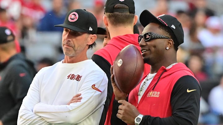 Jan 5, 2025; Glendale, Arizona, USA; San Francisco 49ers head coach Kyle Shanahan (left) and wide receiver Deebo Samuel Sr. (right) look on prior to the game against the Arizona Cardinals at State Farm Stadium. Mandatory Credit: Matt Kartozian-Imagn Images