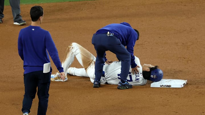 Los Angeles Dodgers designated hitter Shohei Ohtani (17) reacts after injuring his shoulder against the New York Yankees in the seventh inning for game two of the 2024 MLB World Series at Dodger Stadium on Oct 26. Los Angeles Dodgers designated hitter Shohei Ohtani (17) reacts after injuring his shoulder against the New York Yankees in the seventh inning for game two of the 2024 MLB World Series at Dodger Stadium on Oct 26.