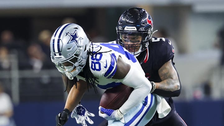 Nov 18, 2024; Arlington, Texas, USA;  Dallas Cowboys wide receiver CeeDee Lamb (88) runs with the ball as Houston Texans safety Jalen Pitre (5) defends during the first half at AT&T Stadium. Mandatory Credit: Kevin Jairaj-Imagn Images
