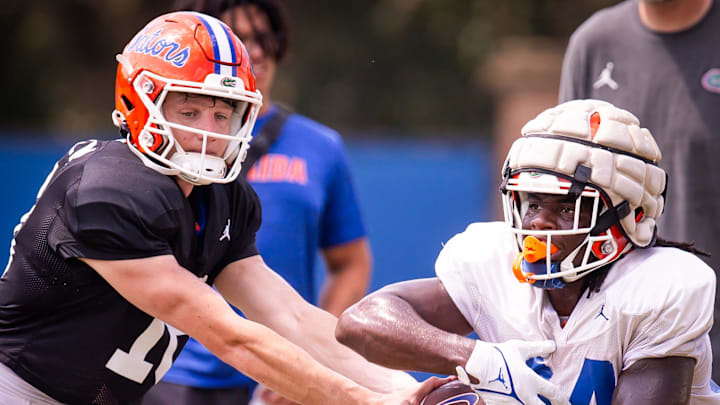 Florida Gators quarterback Aidan Warner (16) makes a hand off to Florida Gators running back Ja'Kobi Jackson (24) during Fall practice at Sanders Practice Fields in Gainesville, FL on Tuesday, August 13, 2024. [Doug Engle/Gainesville Sun]