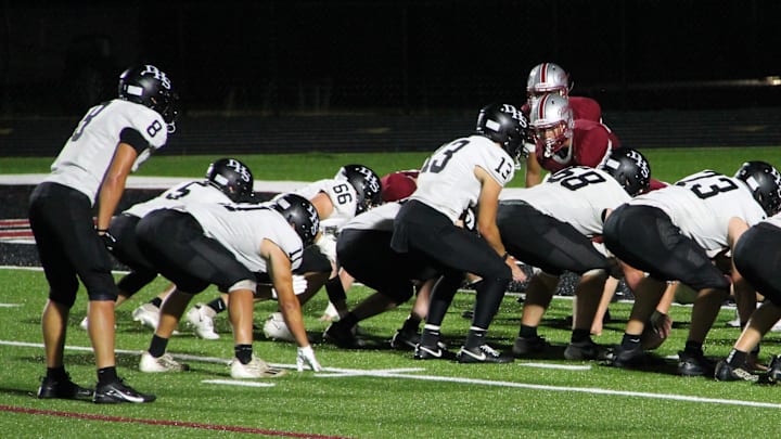Darlington quarterback Zeke Zuberbuhler (13) prepares to take the snap in a season-opening non-conference game at  Platteville on Aug. 22, 2025.