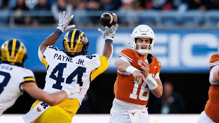 Dec 31, 2025; Orlando, FL, USA; Michigan Wolverines defensive lineman Damon Payne (44) tips a pass from Texas Longhorns quarterback Arch Manning (16) during the first half at Camping World Stadium. Mandatory Credit: Matt Pendleton-Imagn Images