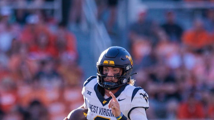 Oct 5, 2024; Stillwater, Oklahoma, USA; West Virginia Mountaineers quarterback Garrett Greene (6) runs the ball against the Oklahoma State Cowboys during the fourth quarter at Boone Pickens Stadium. Mandatory Credit: William Purnell-Imagn Images