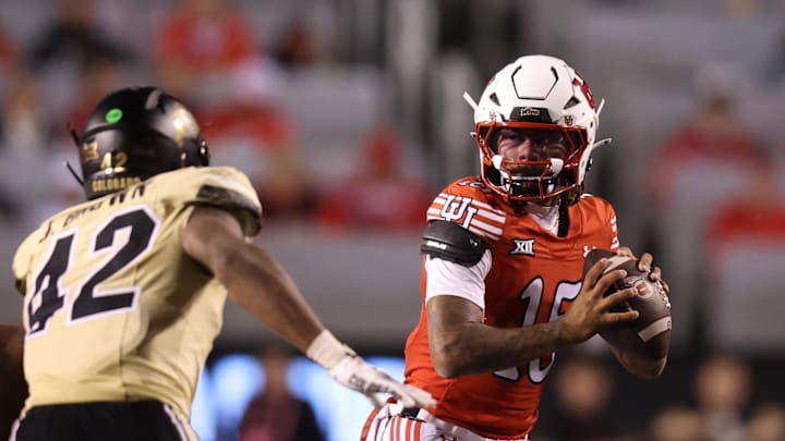 Utah Utes quarterback Byrd Ficklin (15) is pressured by Colorado Buffaloes linebacker Jeremiah Brown (42) during the third quarter at Rice-Eccles Stadium.