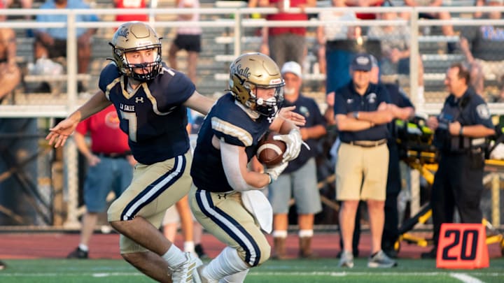 La Salle's Gavin Sidwar hands off to Stevie Davis in a football game against North Penn at North Penn High School in Lansdale on Friday, August 26, 2022. The Explorers defeated the Knights 37-28.