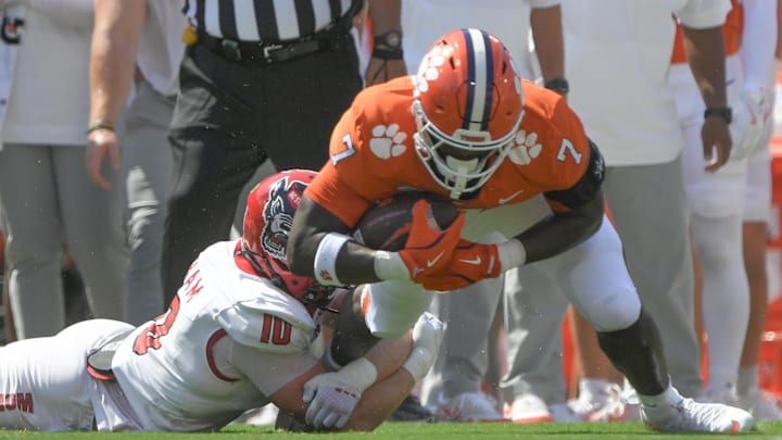 Sep 21, 2024; Clemson, South Carolina, USA; Clemson Tigers running back Phil Mafah (7) suffers an apparent injury as he his tackled by North Carolina State Wolfpack linebacker Caden Fordham (10) during the first quarter at Memorial Stadium. Mandatory Credit: Ken Ruinard-Imagn Images