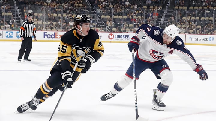 Oct 4, 2024; Pittsburgh, Pennsylvania, USA;  Pittsburgh Penguins defenseman Harrison Brunicke (45) skates in on goal against Columbus Blue Jackets center Sean Kuraly (7) during the first period at PPG Paints Arena. Mandatory Credit: Charles LeClaire-Imagn Images