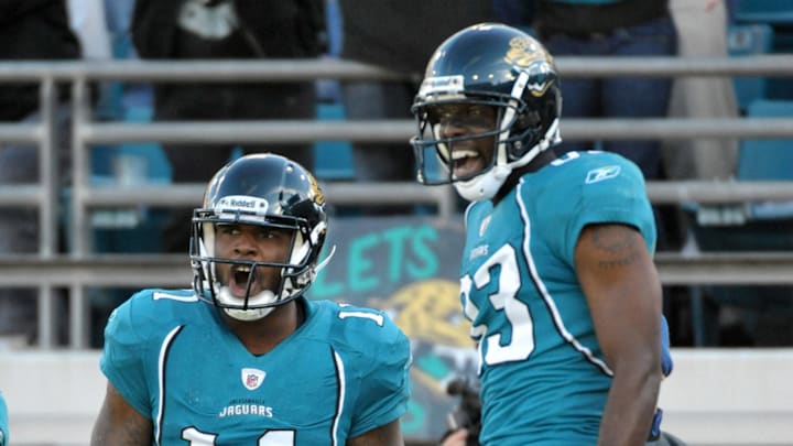 Dec 12, 2010; Jacksonville, FL, USA; Jacksonville Jaguars receiver Mike Sims Walker (11) celebrates with receiver Jason Hill (83) after scoring on a 10-yard touchdown pass in the third quarter against the Oakland Raiders at EverBank Field. The Jaguars defeated the Raiders 38-31. Mandatory Credit: Kirby Lee/Image of Sport-Imagn Images