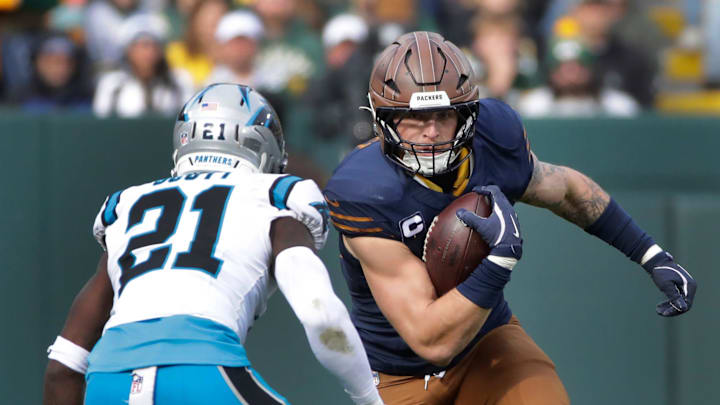Green Bay Packers tight end Tucker Kraft (85) runs on a catch against Carolina Panthers safety Nick Scott (21) during their football game Sunday, November 2, 2025, at Lambeau Field in Green Bay, Wisconsin.