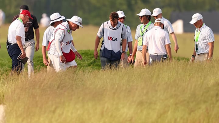 Officials, caddies and golfers search for the ball of Rasmus Neergaard-Petersen on the 14th hole during the first round of the U.S. Open. 