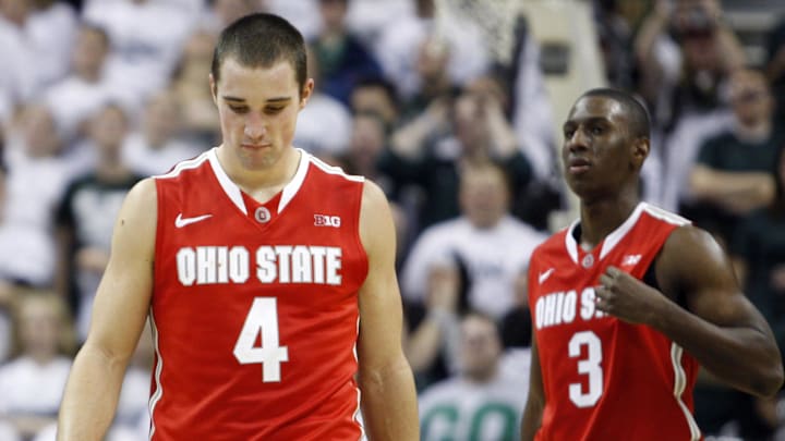 Jan 7, 2014; East Lansing, MI, USA; Ohio State Buckeyes guard Aaron Craft (4) and guard Shannon Scott (3) react during overtime against the Michigan State Spartans at Jack Breslin Student Events Center. Spartans beat the Buckeyes 72-68 in overtime. Mandatory Credit: Raj Mehta-Imagn Images