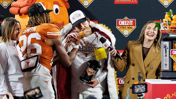 Dec 31, 2025; Orlando, FL, USA; Texas Longhorns quarterback Arch Manning (16) bites into a turkey leg with the help from Texas Longhorns linebacker Ty'Anthony Smith (26) and ESPN reporter Alyssa Lang after a game at Camping World Stadium. Mandatory Credit: Matt Pendleton-Imagn Images Dec 31, 2025; Orlando, FL, USA; Texas Longhorns quarterback Arch Manning (16) bites into a turkey leg with the help from Texas Longhorns linebacker Ty'Anthony Smith (26) and ESPN reporter Alyssa Lang after a game at Camping World Stadium. Mandatory Credit: Matt Pendleton-Imagn Images
