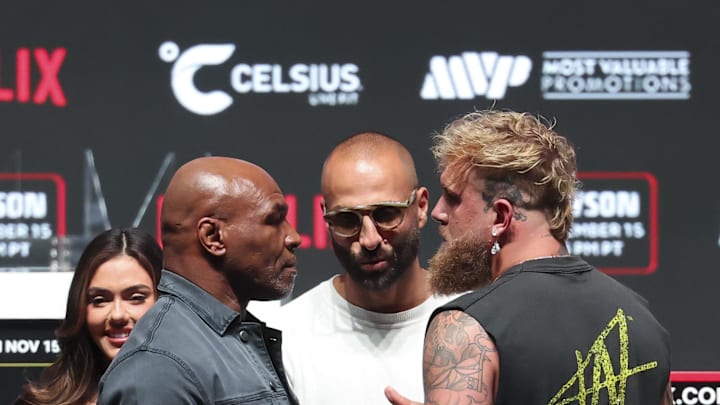 Nov 13, 2024; Irving, TX, USA;  Jake Paul (right) faces off with Mike Tyson after their press conference at The Pavilion at Toyota Music Factory. 