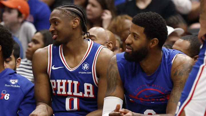 Apr 1, 2026; Washington, District of Columbia, USA; Philadelphia 76ers guard Tyrese Maxey (0) and 76ers forward Paul George (8) look on from the bench against the Washington Wizards in the second half at Capital One Arena. Mandatory Credit: Geoff Burke-Imagn Images
