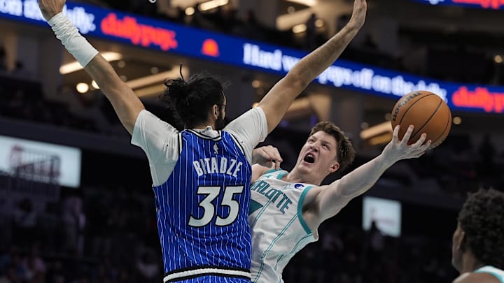 Charlotte Hornets guard Kon Knueppel (7) drives to the basket against Orlando Magic center Goga Bitadze 